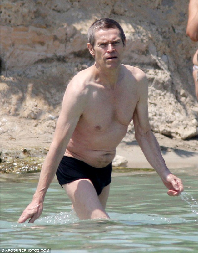 Shirtless Willem Dafoe, 60, relaxes on beach holiday with his stunning biki...